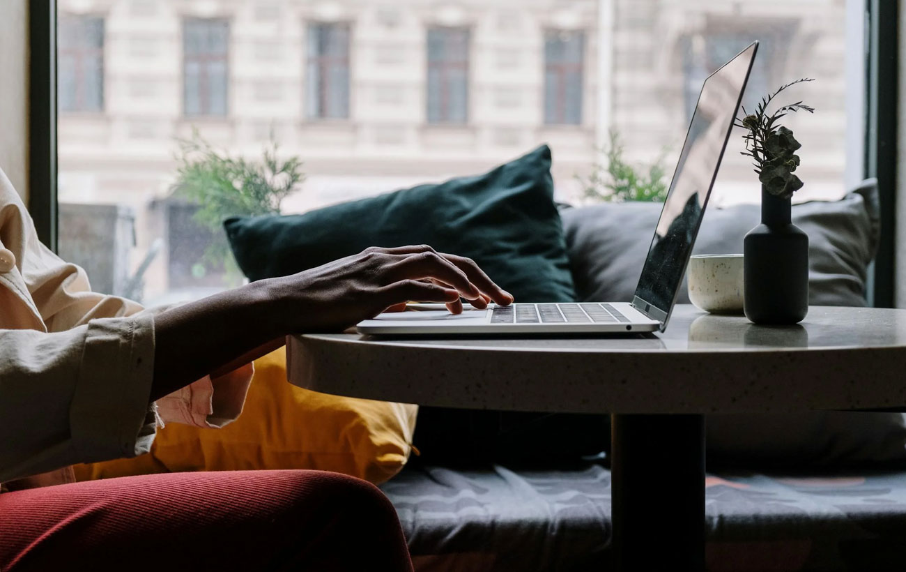 A guy at a coffee shop browsing on his Macbook Pro.